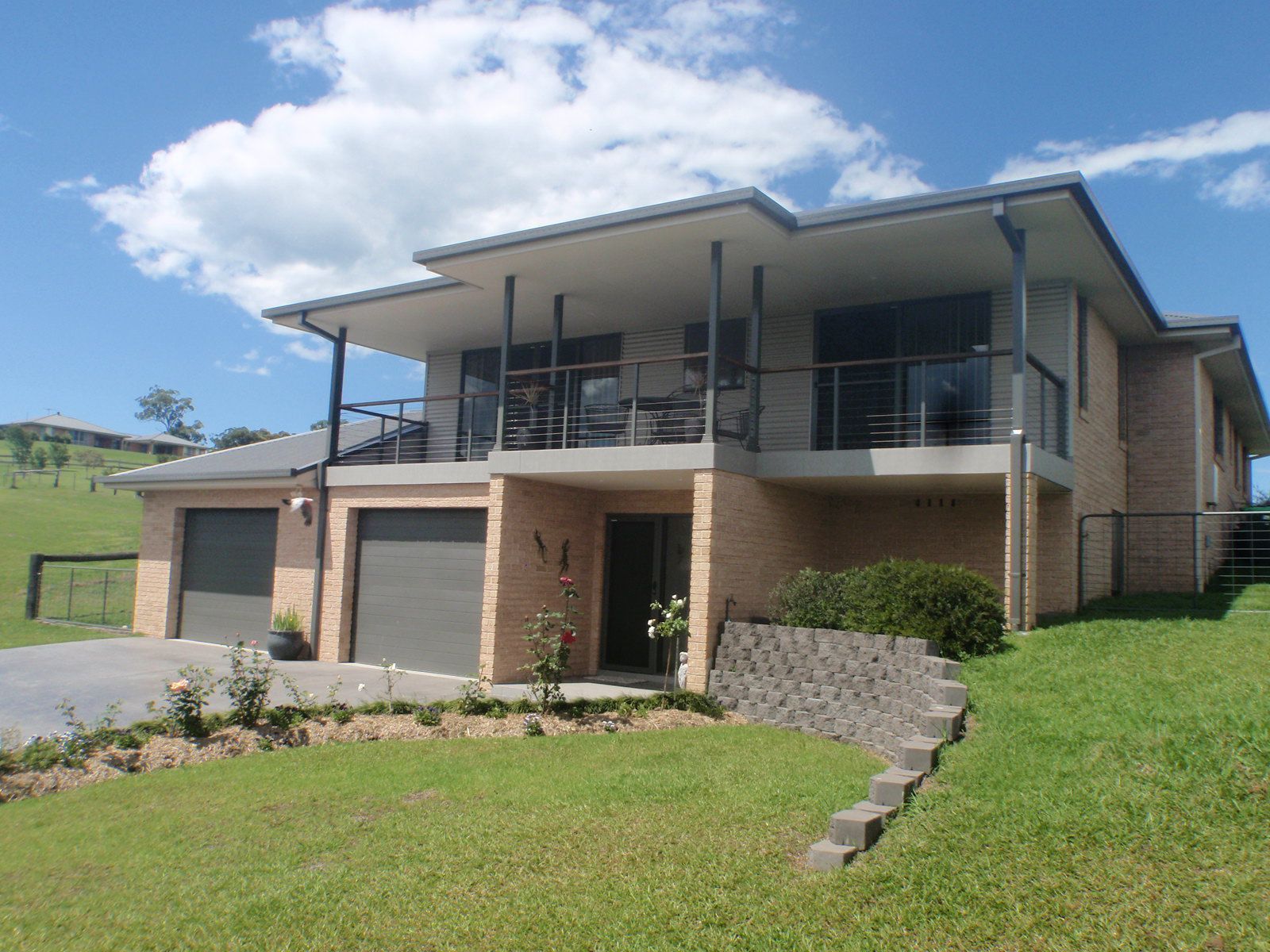 A Large House With Two Garages And A Balcony — Patterson Glass Works in Kempsey, NSW