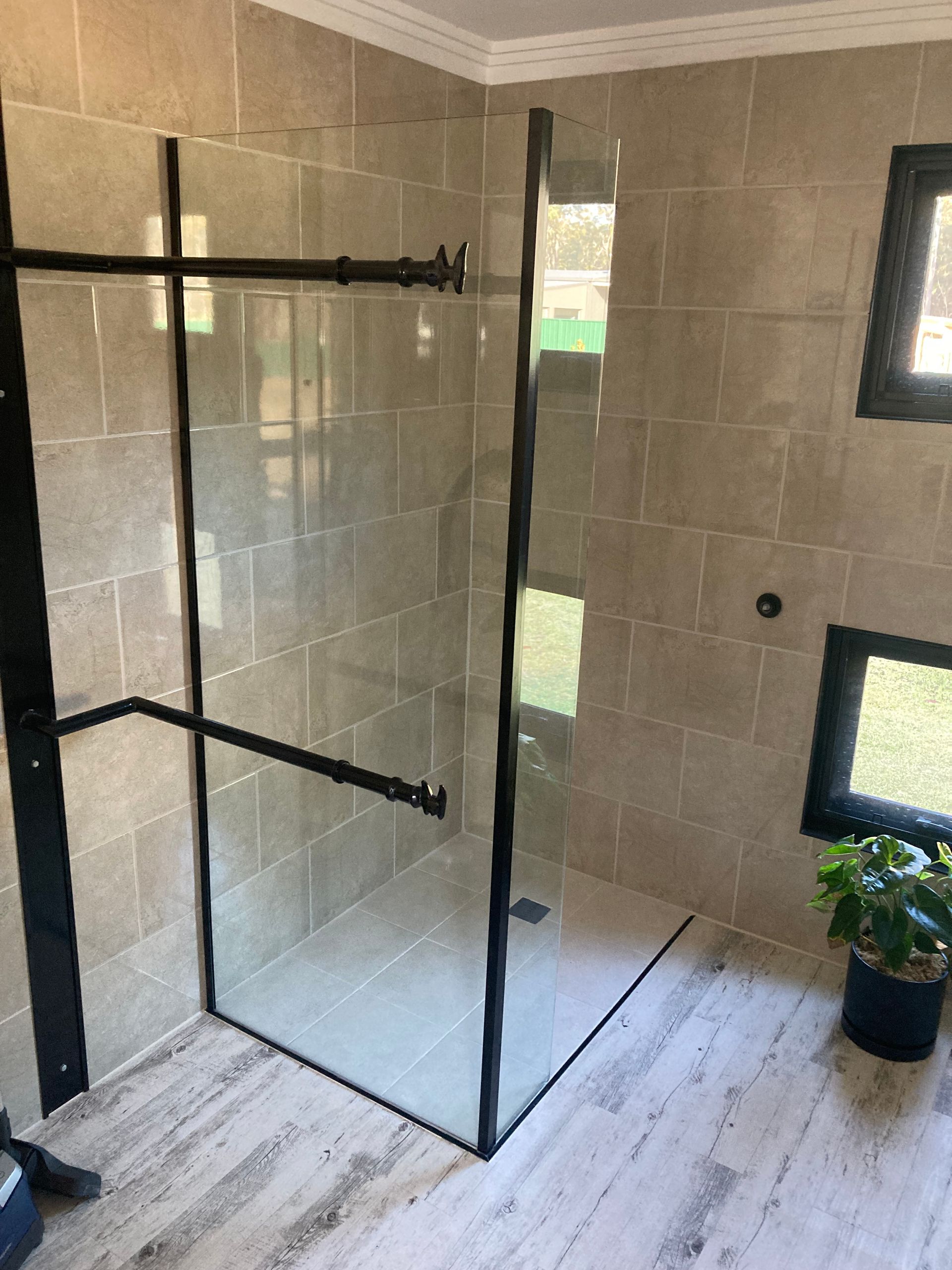 A Bathroom With a Sliding Glass Shower Door — Patterson Glass Works in Kempsey, NSW