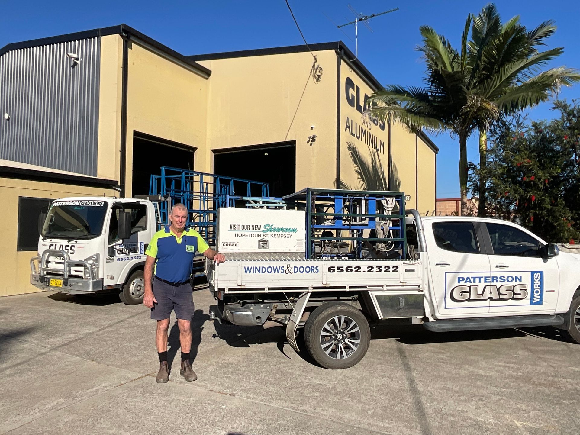 A White Window With a Shelf Underneath It on the Side of a House — Patterson Glass Works in Kempsey, NSW
