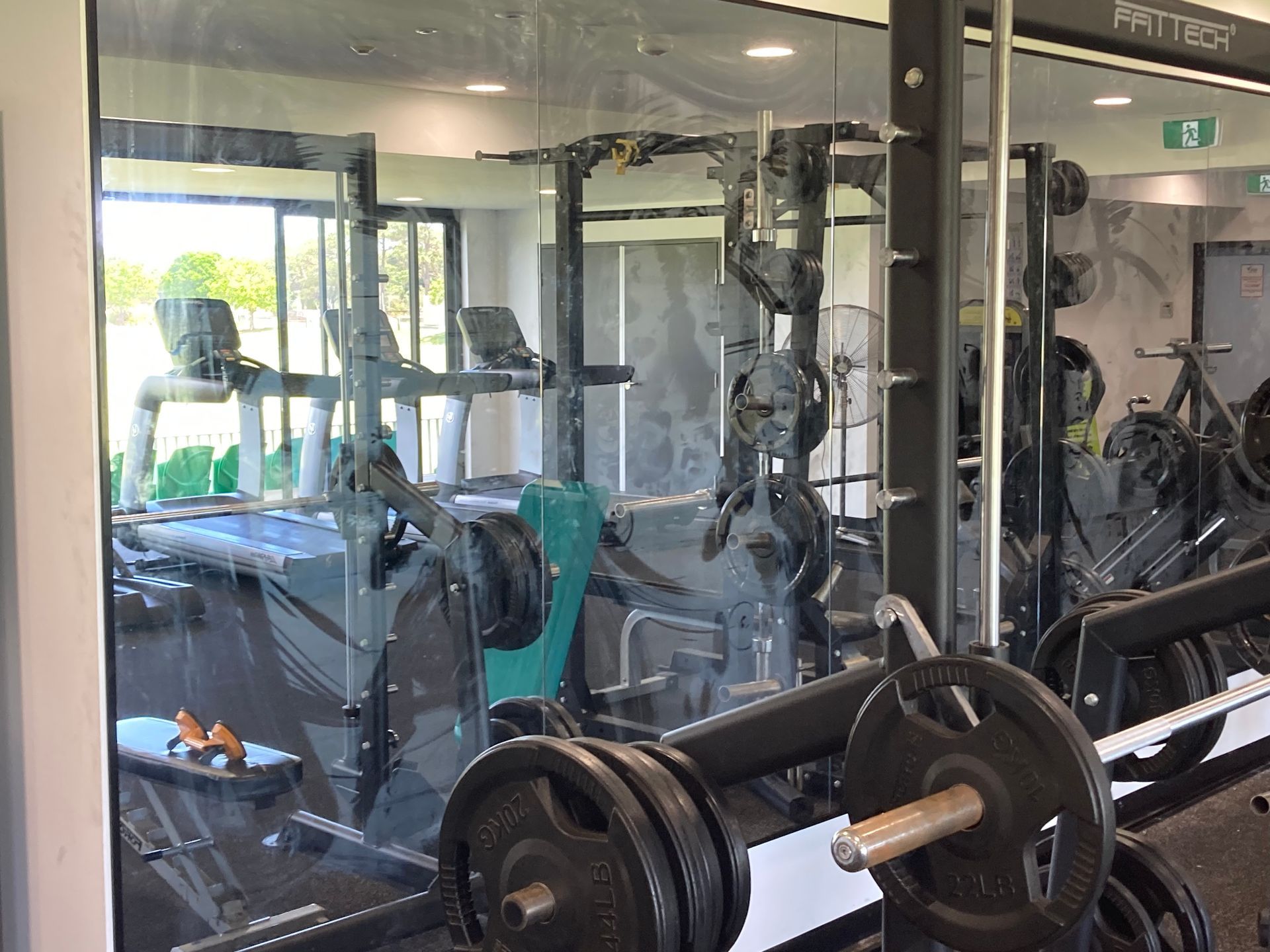 A gym with a lot of exercise equipment and a mirror. — Patterson Glass Works in Kempsey, NSW