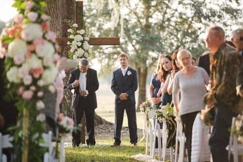 A bride and groom are walking down the aisle at a wedding ceremony.