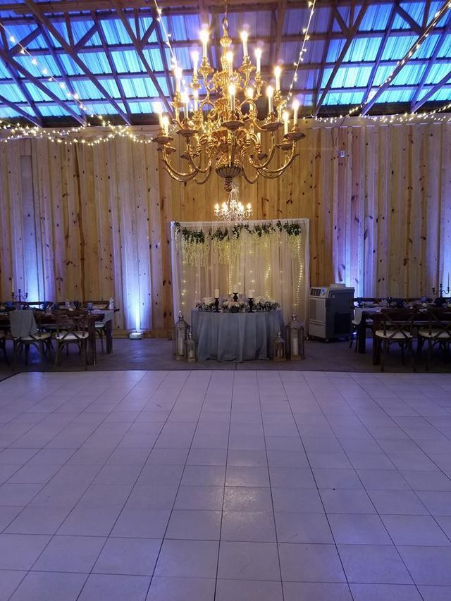 A large room with a table and chairs and a chandelier.