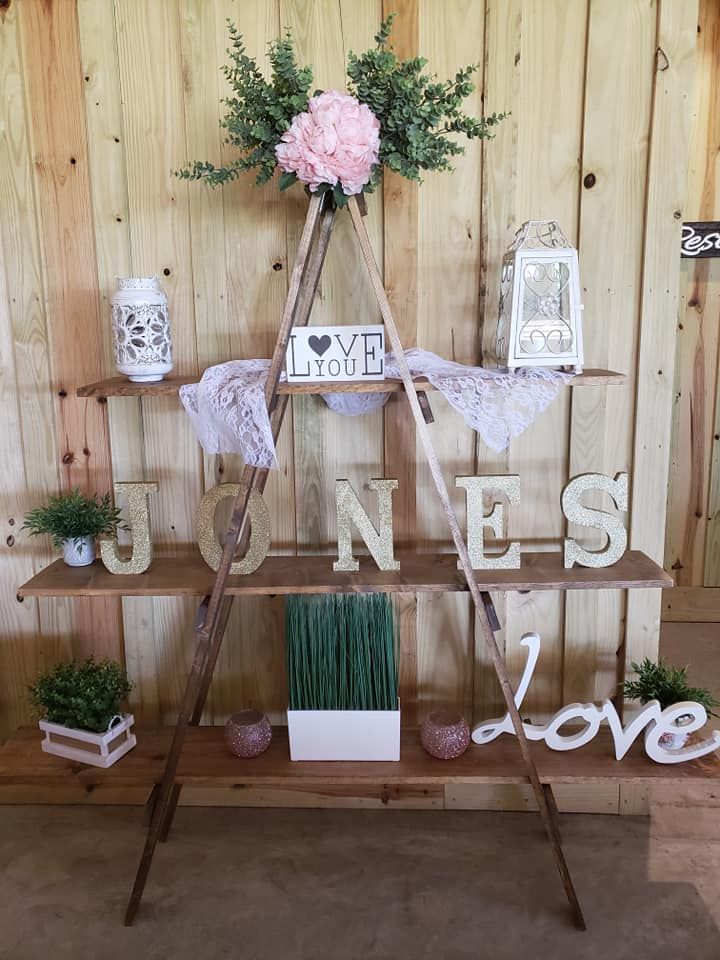 A wooden ladder is sitting in front of a wooden wall.