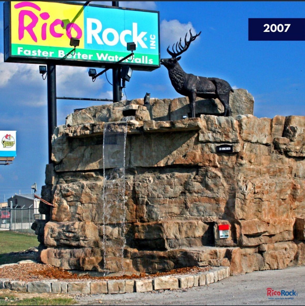 Rico Rock sign with artificial rock waterfall and elk statue. 2007 date.