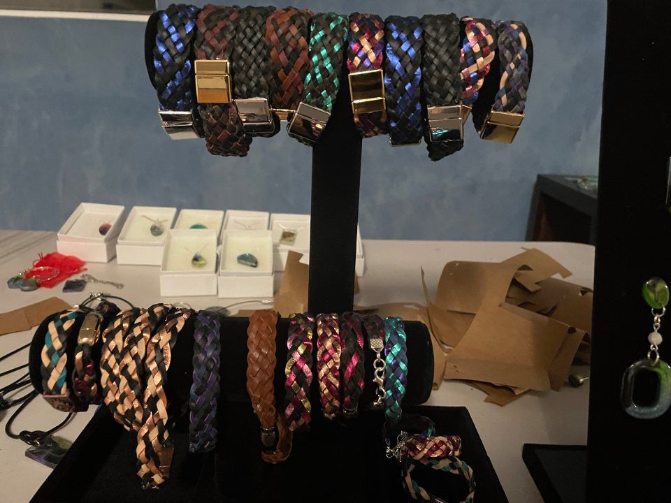 Bracelets of various colors and designs displayed on a table.
