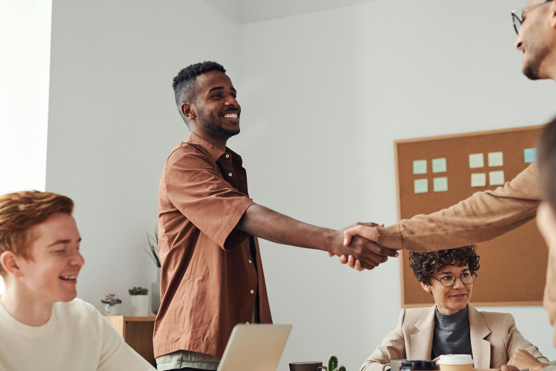 A group of people are shaking hands in an office.