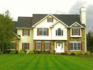 A large house with a lush green lawn in front of it