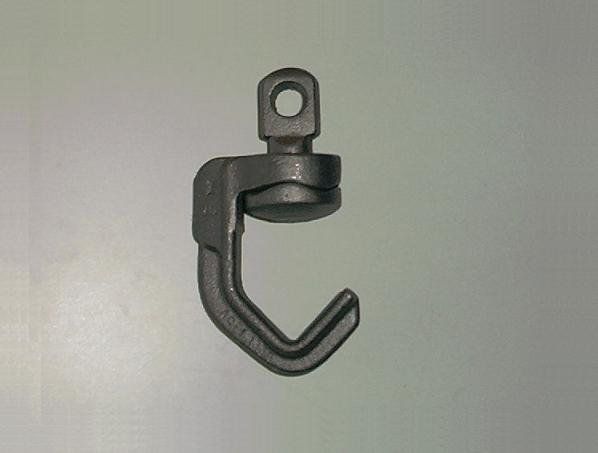 A black hook with a hole in the middle on a white surface