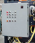 A control panel with buttons and wires attached to it is sitting on top of a machine.
