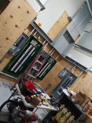 A room with a table and a ladder in it.