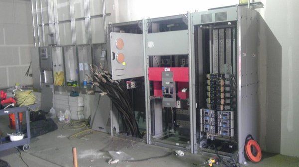 A room with a lot of electrical equipment in it.