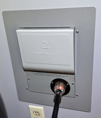 A plug is plugged into a wall mounted electrical outlet.