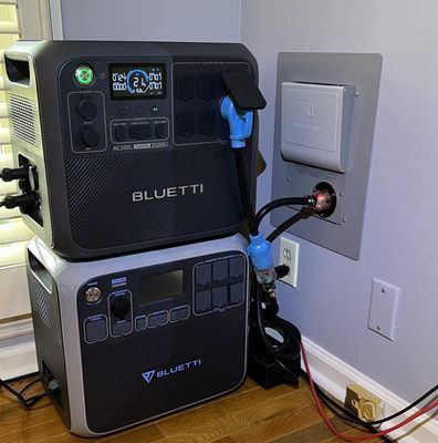 A bluetti power station is stacked on top of each other in a room.