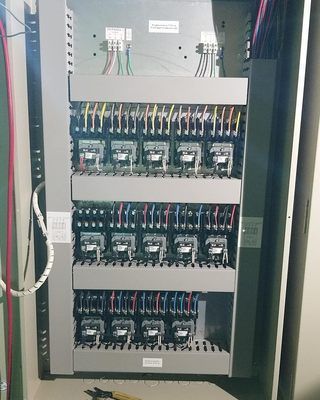 A large electrical box with a lot of wires coming out of it.