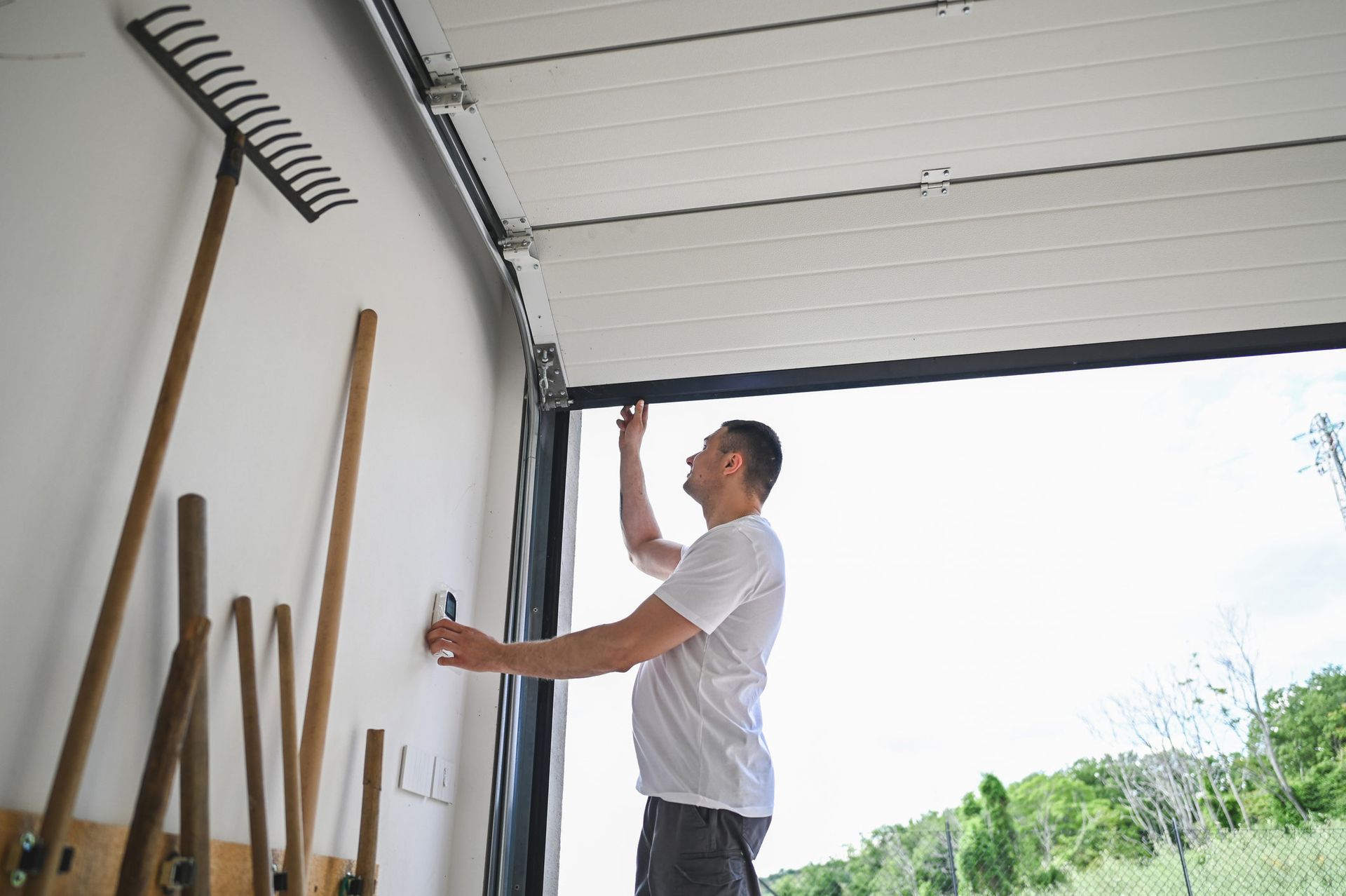 Man repairing garage doorway.