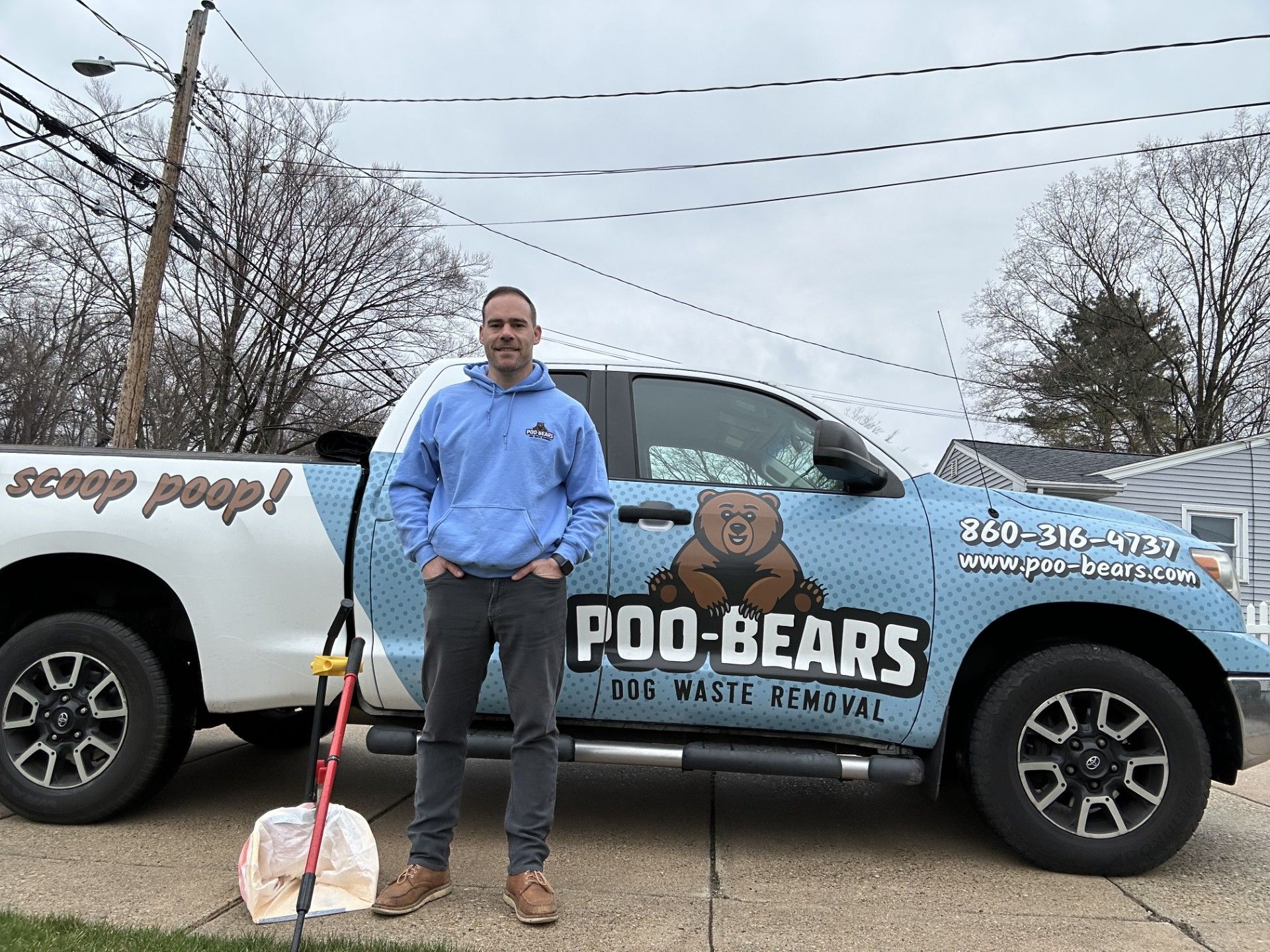 A woman is hugging a husky dog on a white background.