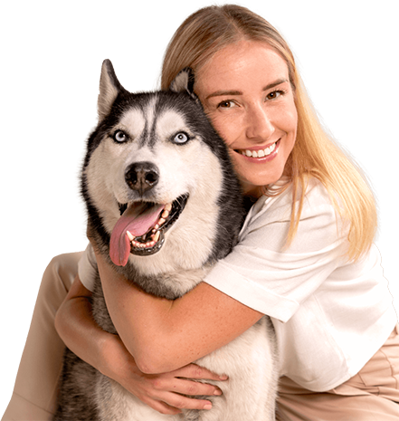 A woman is hugging a husky dog on a white background.