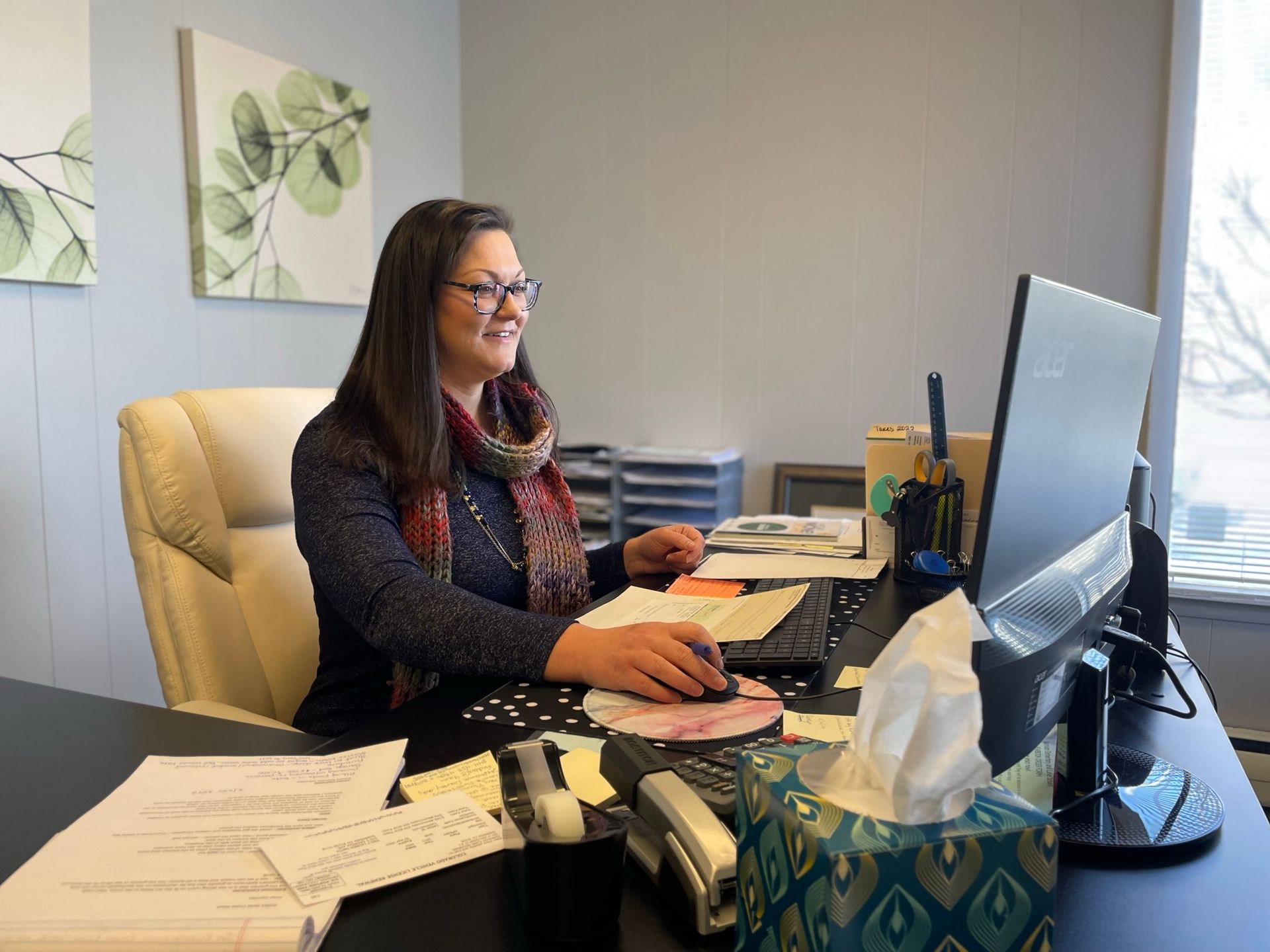 Woman typing on computer at desk