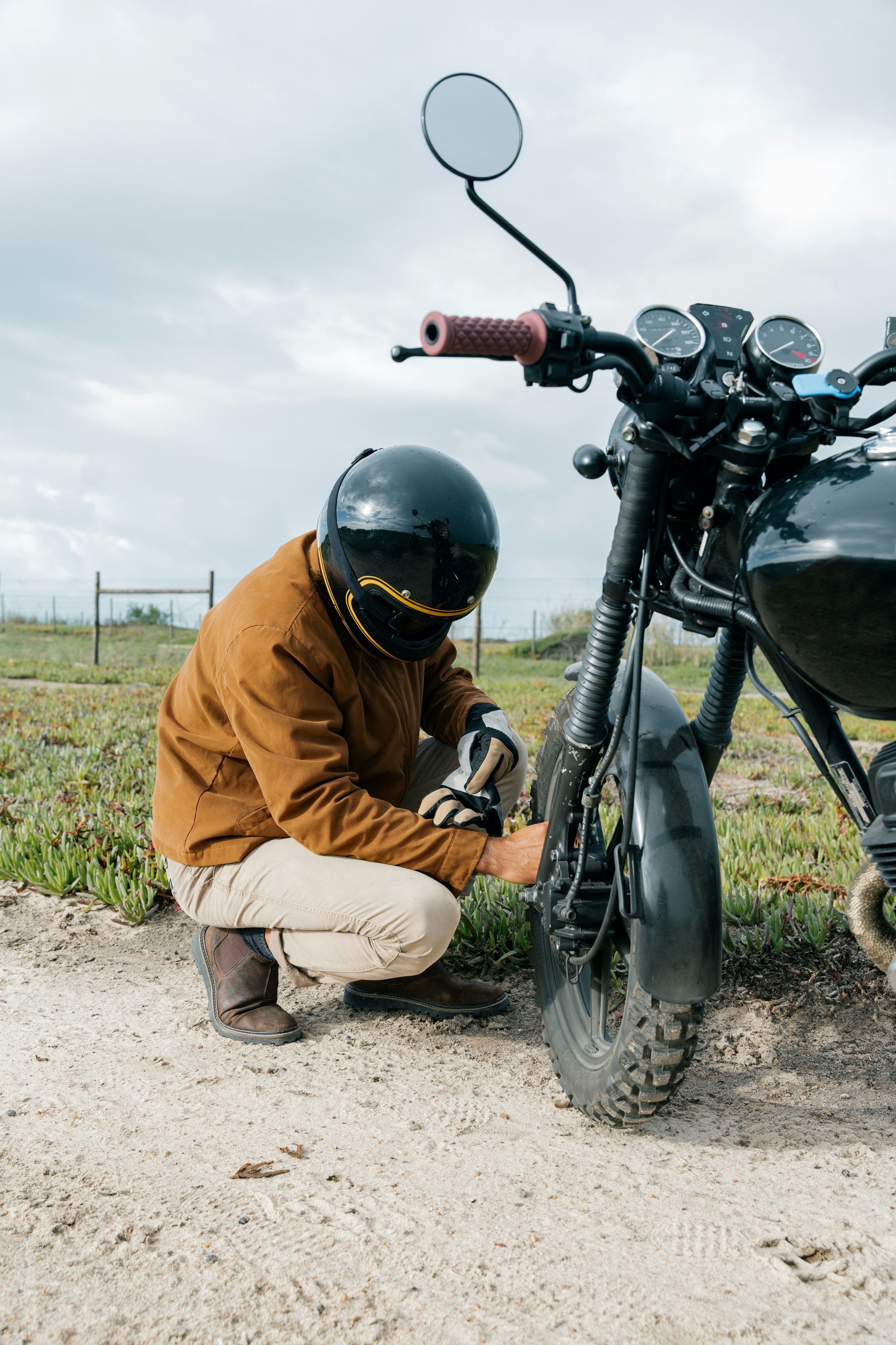 Red car with severe damage to the rear, loaded on a tow truck.