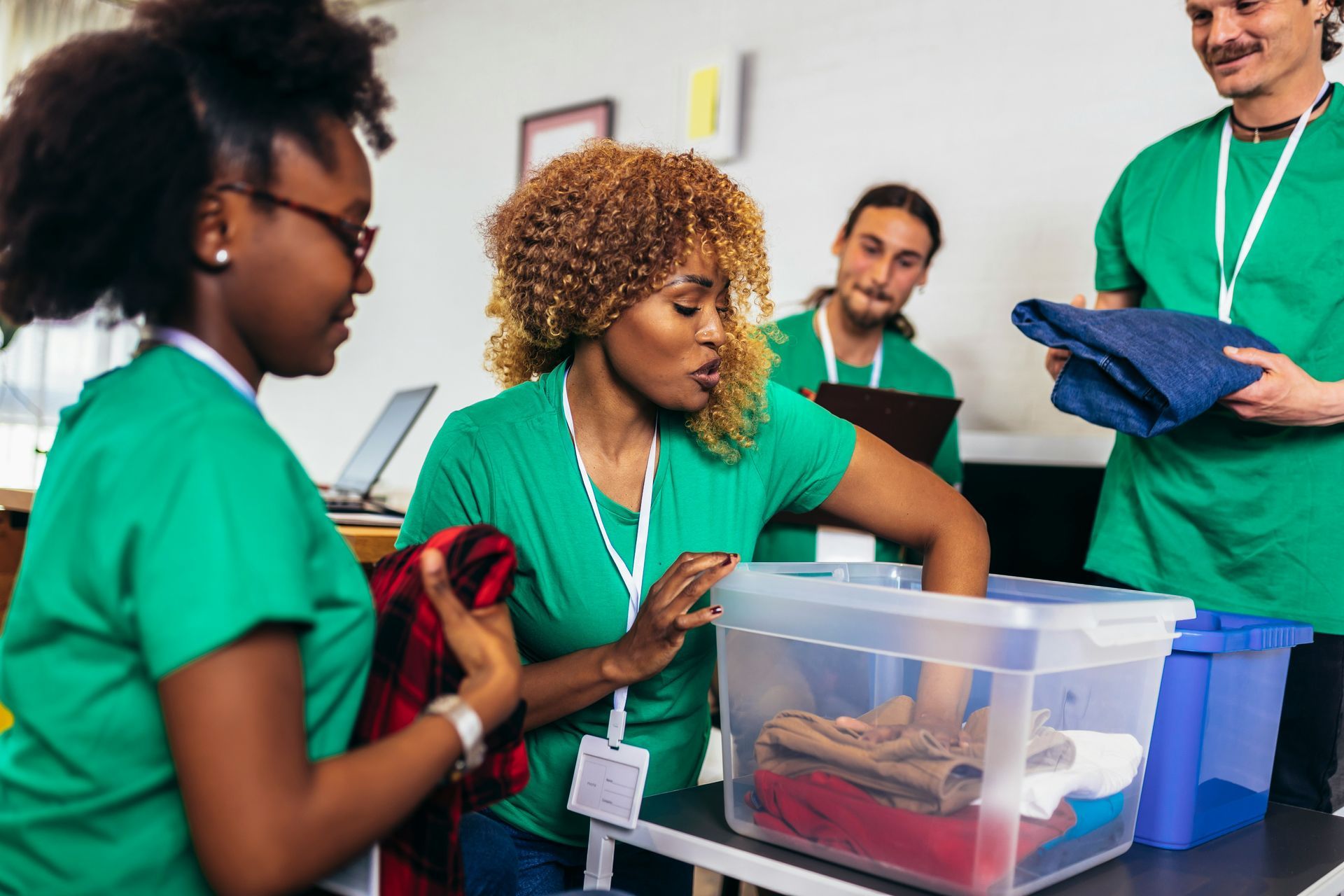 Red car with severe damage to the rear, loaded on a tow truck.