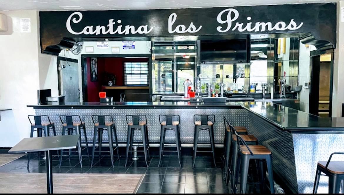 a restaurant with a long bar and a sign that says cantina las primos