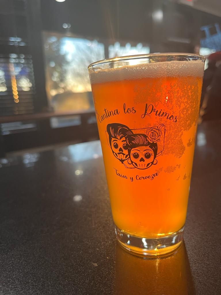 A glass of beer is sitting on a table.