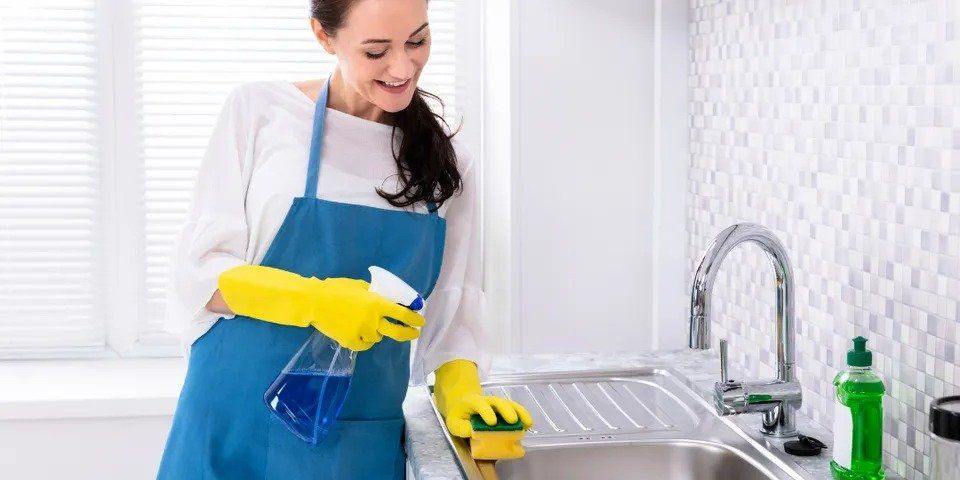 Woman Cleaning Kitchen Sink – Archdale, NC – Queen’s Septic Tank Service