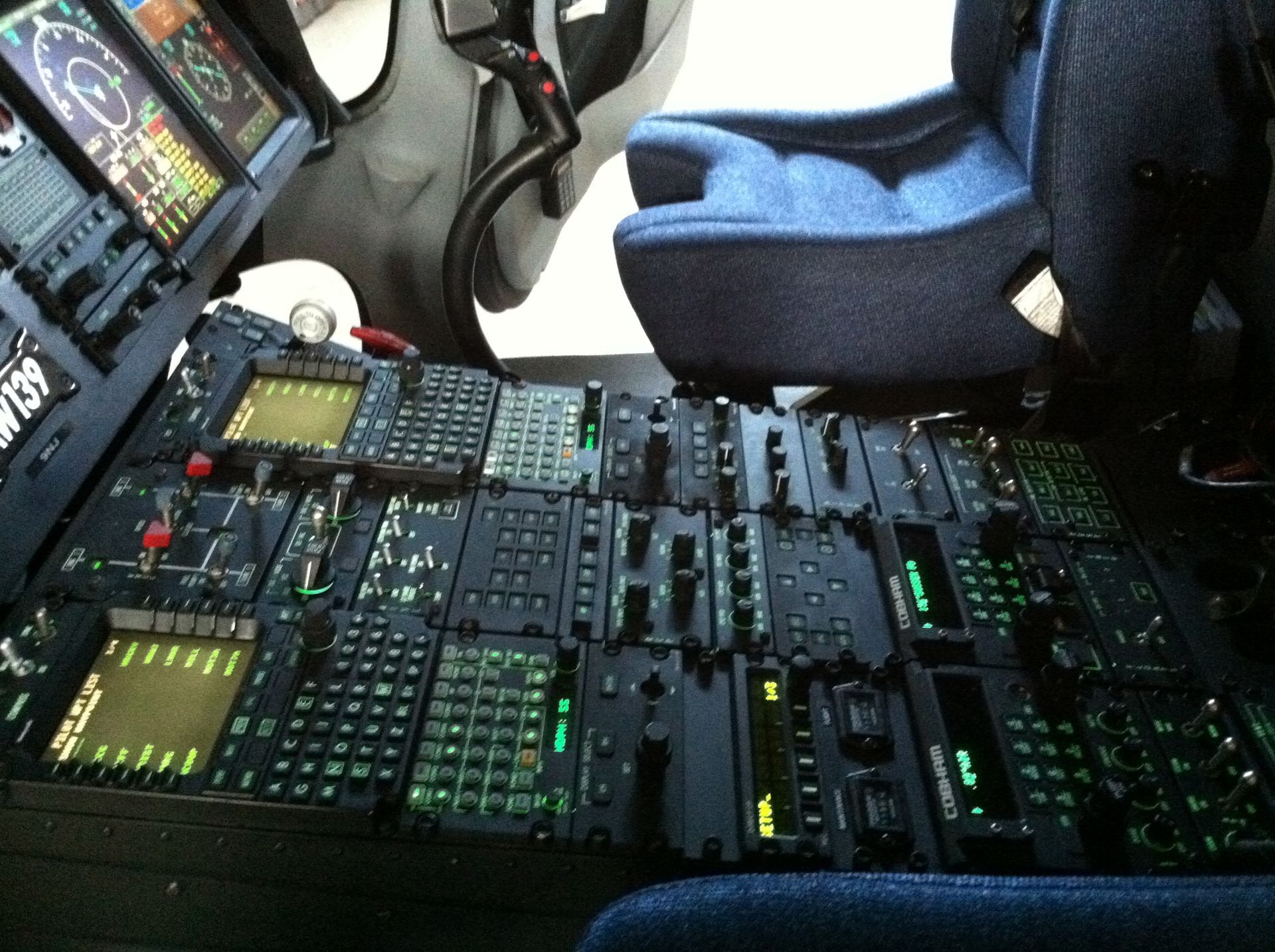 A cockpit of an airplane with a blue seat