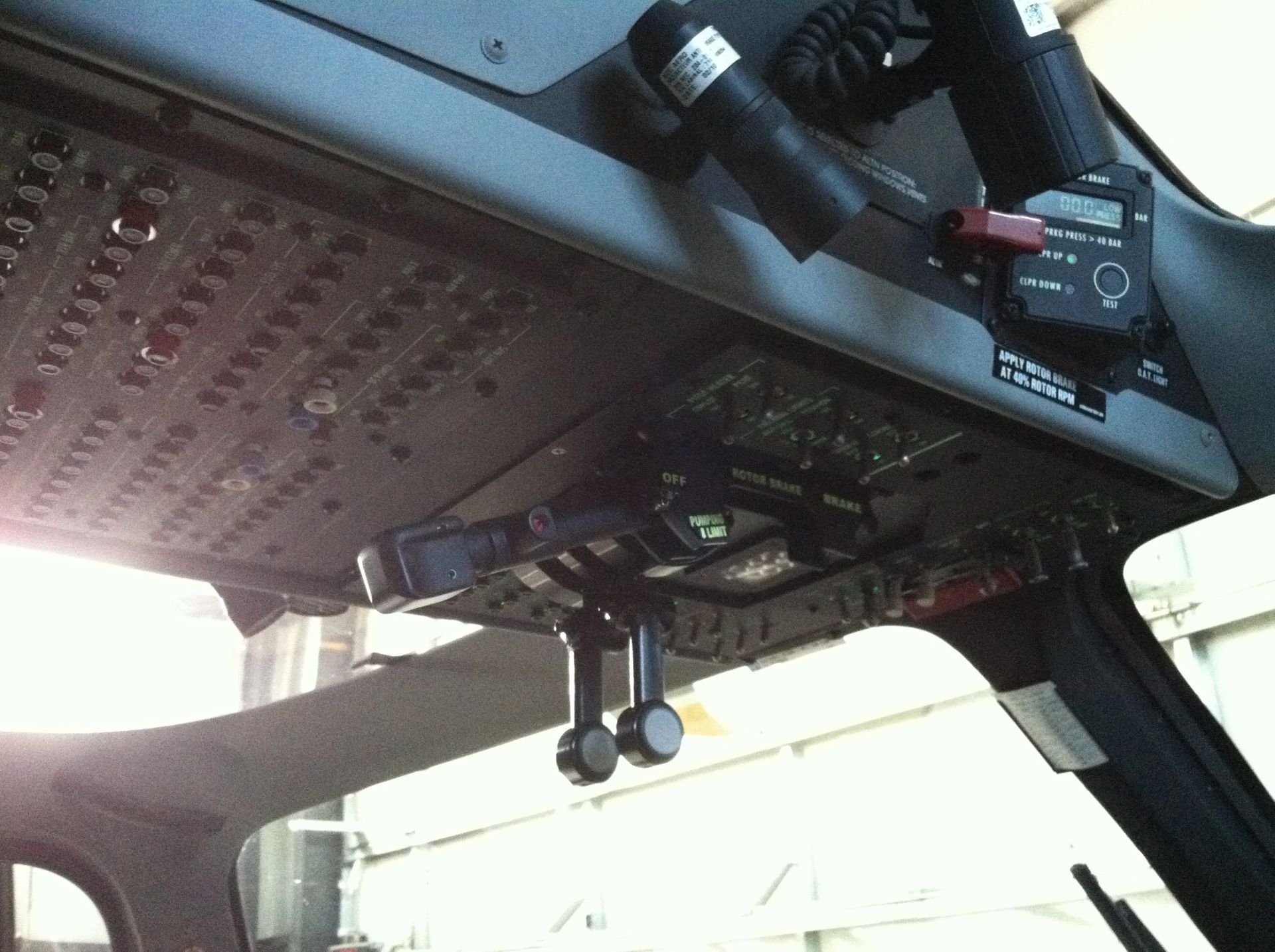 A close up of a helicopter cockpit with a light hanging from it