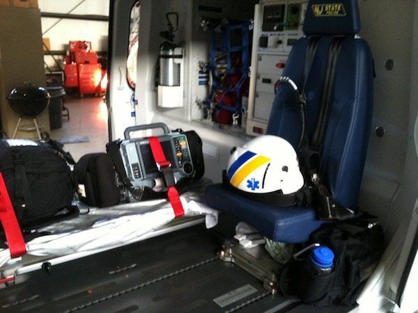 A helmet sits on the back seat of an ambulance