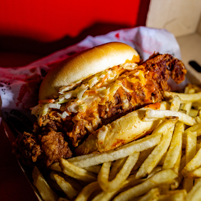 Close up of Clucker's Spicy Clucker Sandwich on a bed of fries.