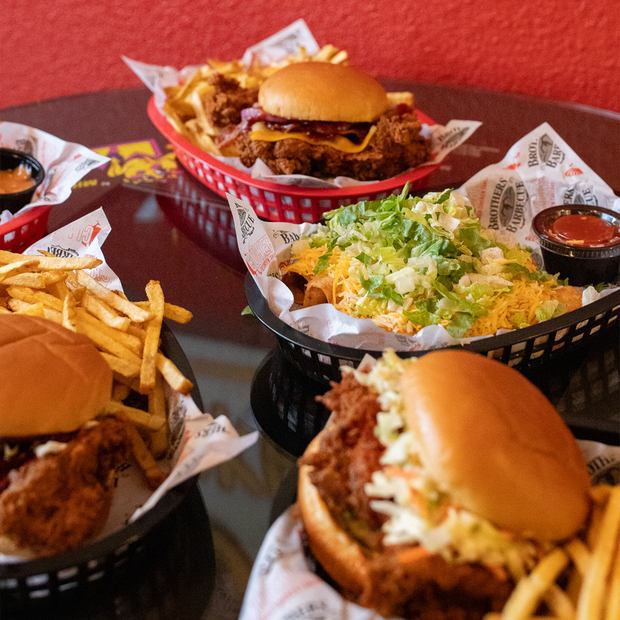 A spread of Cluckers' menu items on a table. 