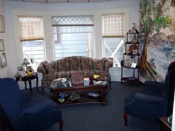 A living room with a couch and chairs and a coffee table