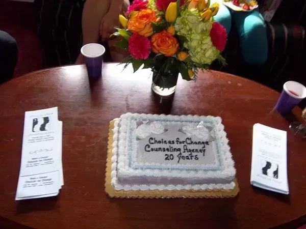 A cake on a table that says 20 years on it