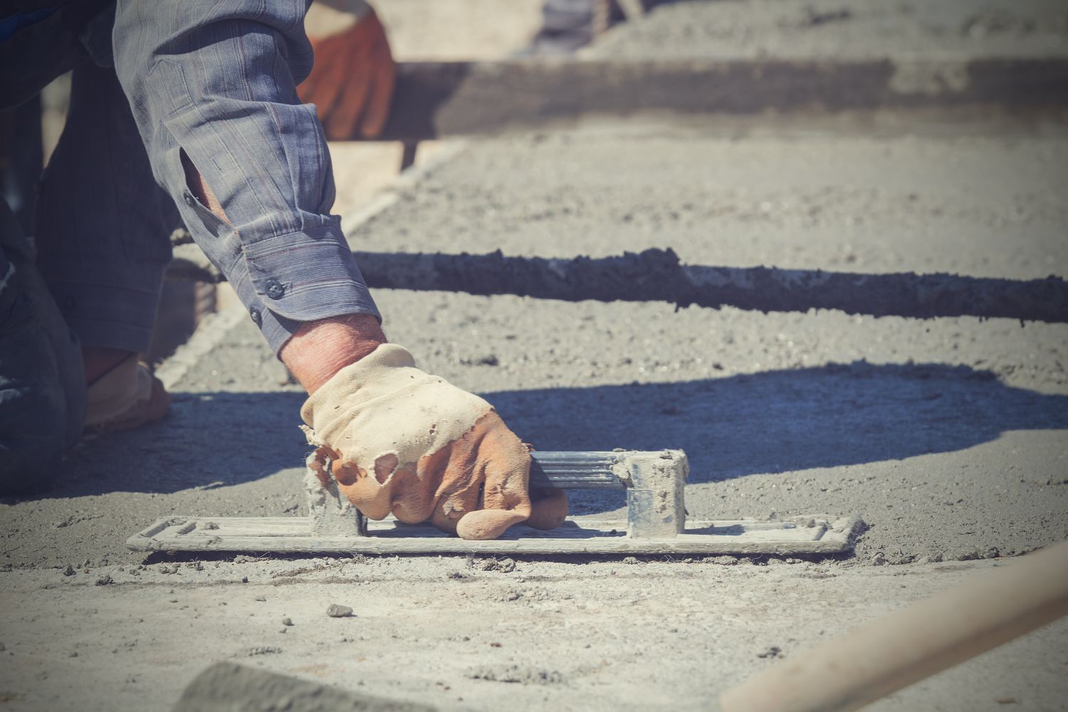 construction workers leveling concrete pavement