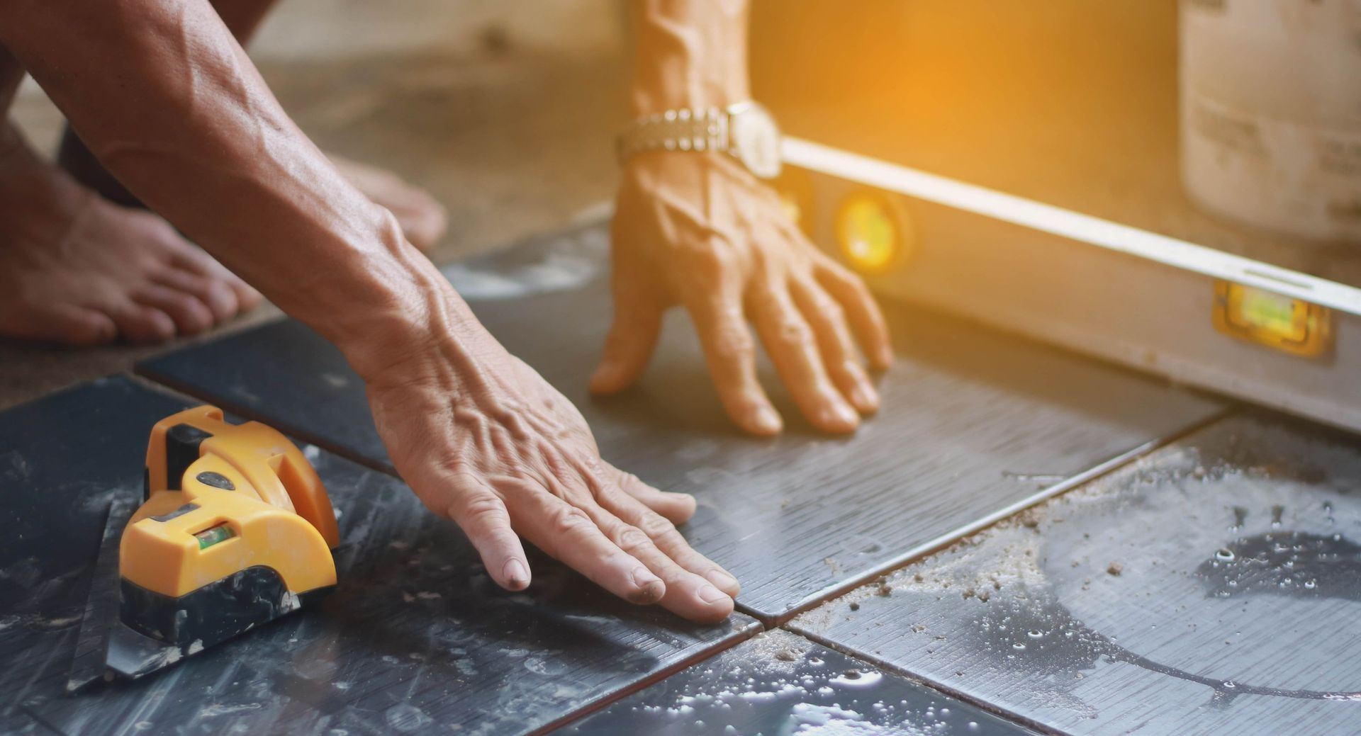 ceramic tiles workers hand tile position