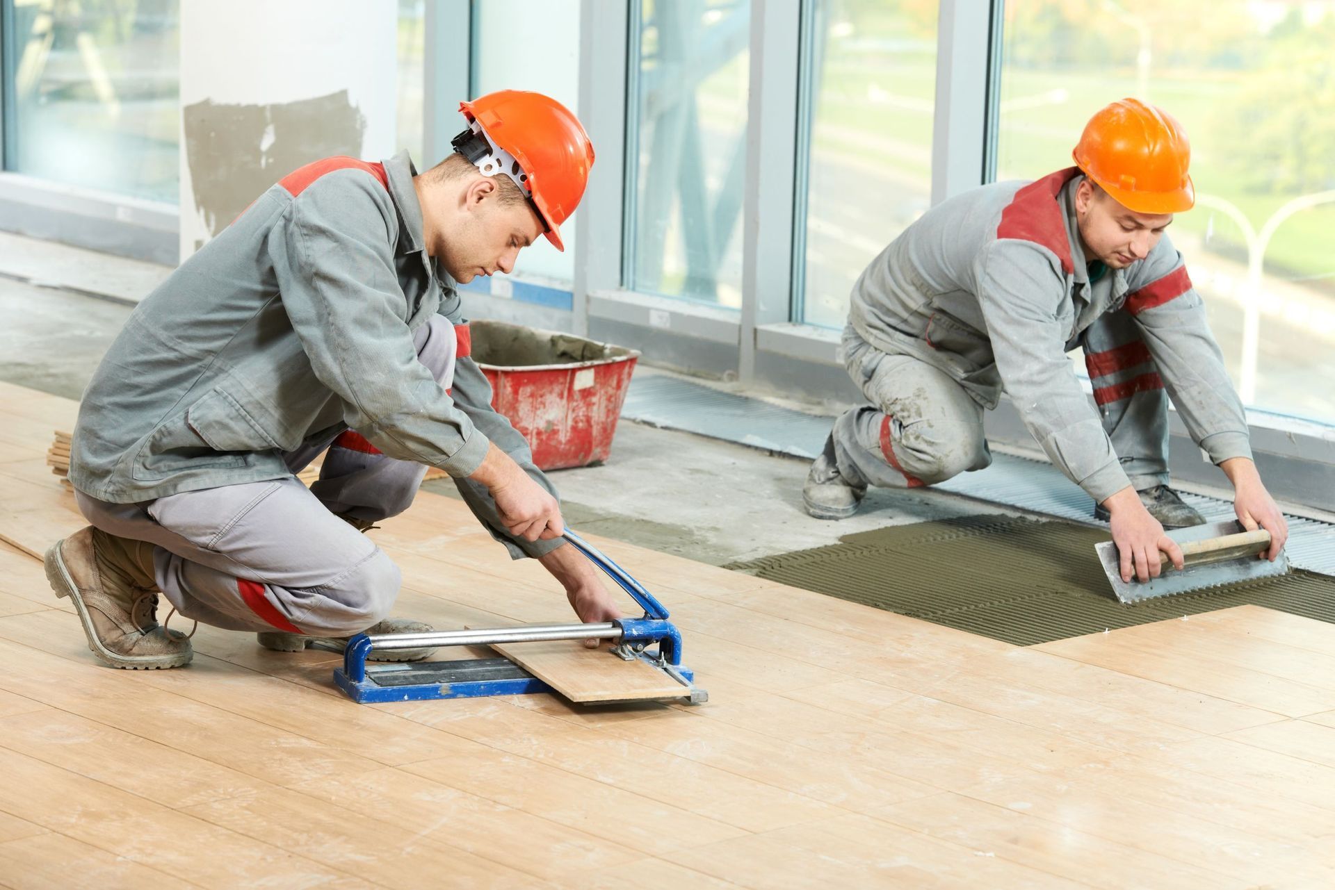 two industrial tiler builder worker installing