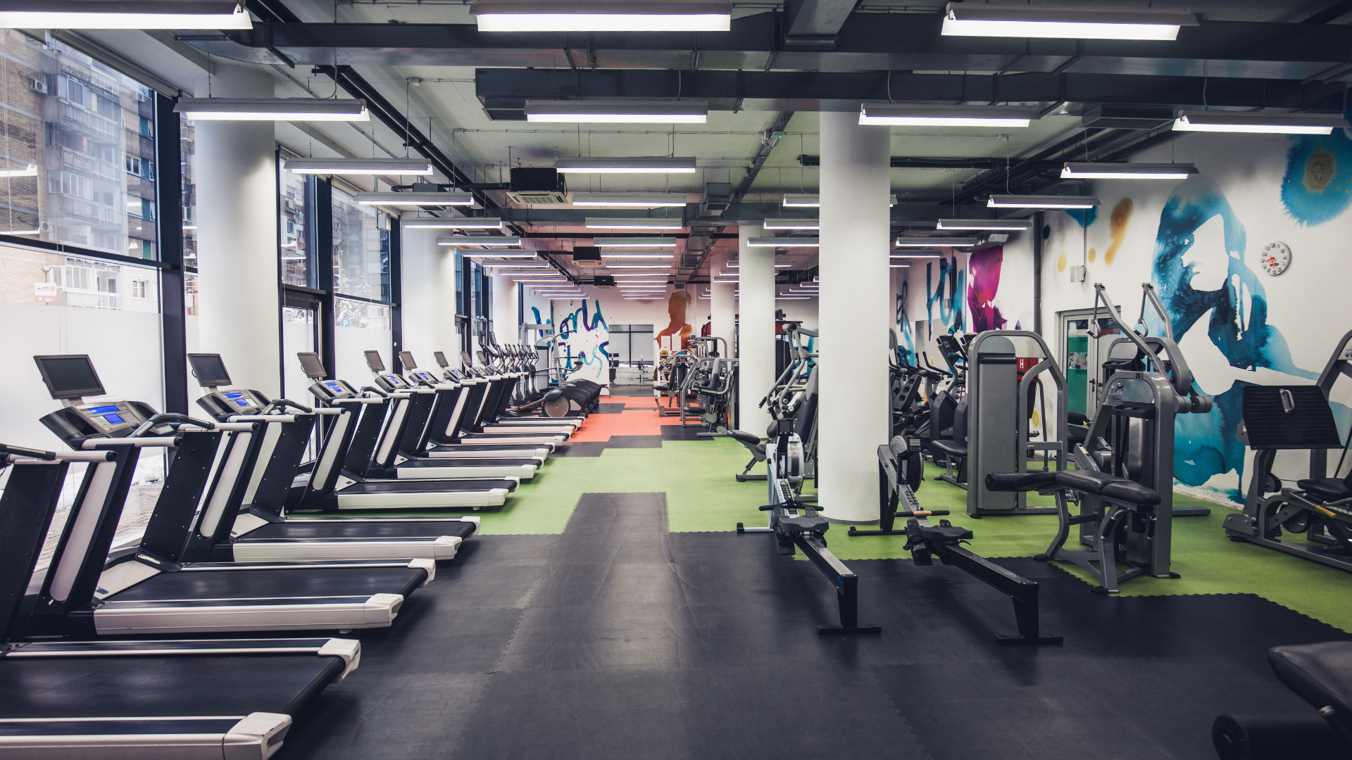 A gym with a lot of treadmills and exercise equipment.
