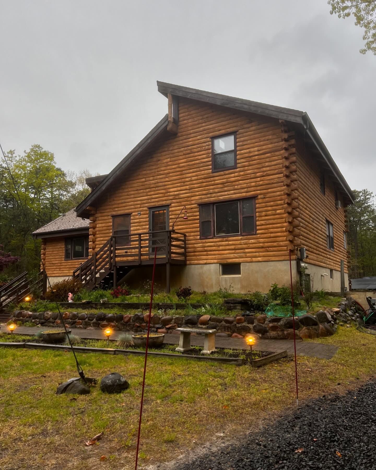 A large wooden house with a lot of windows and stairs