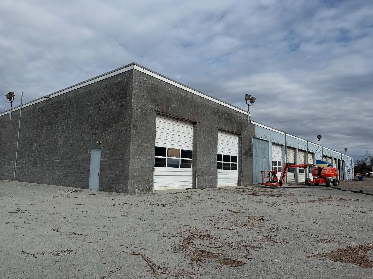 A large brick building with a lot of garage doors
