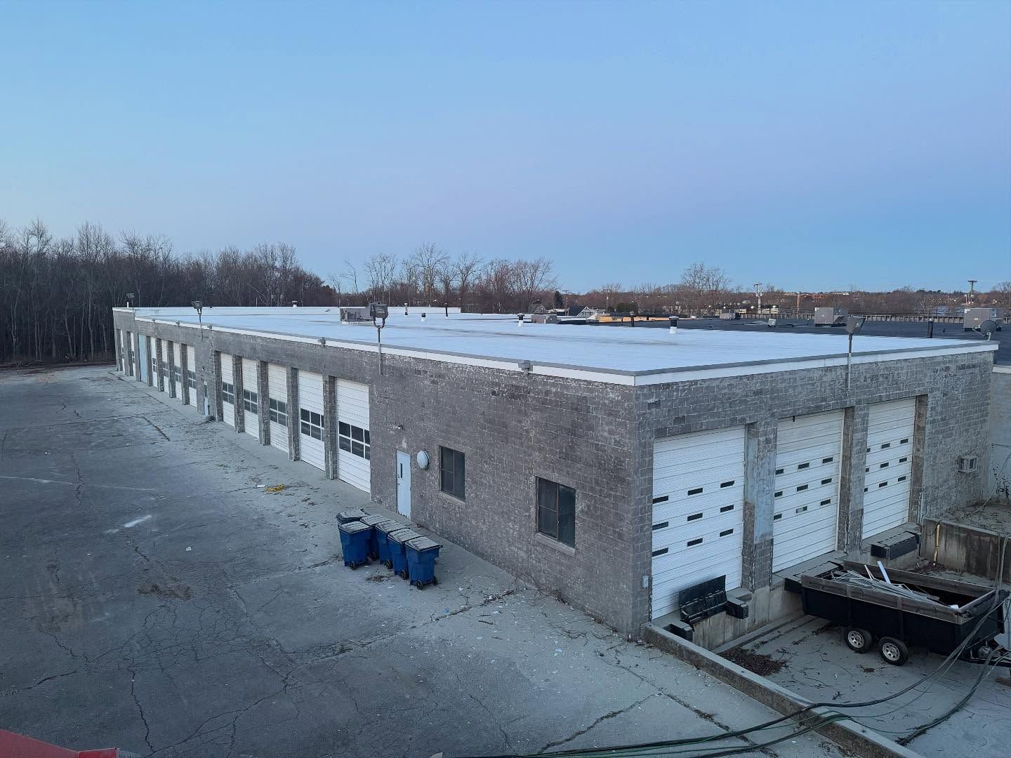 An aerial view of a large building with a lot of garage doors.