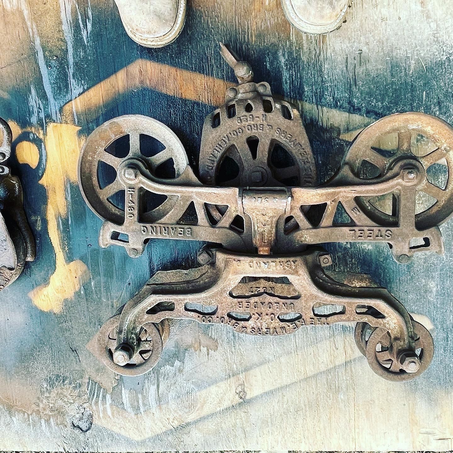 A close up of a metal object with wheels on a table.