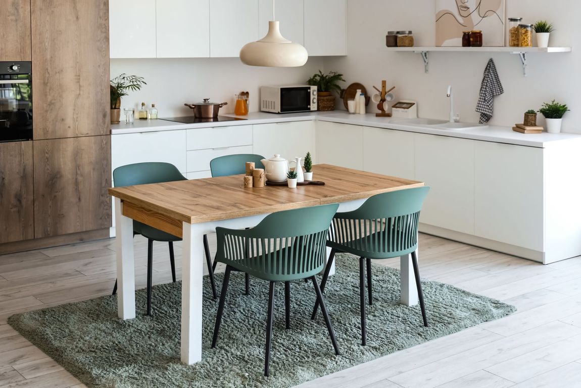 A kitchen with a table and chairs in it