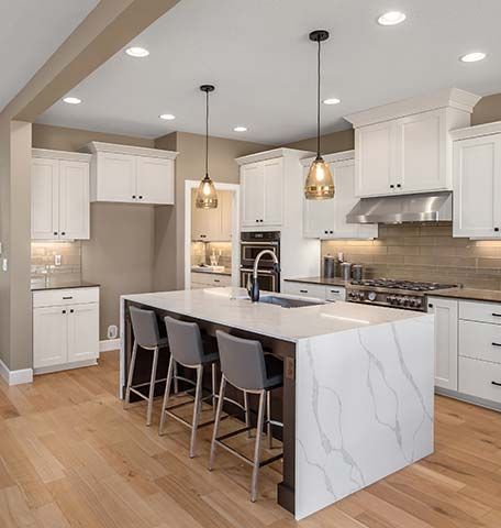 There is a large island in the middle of the kitchen.