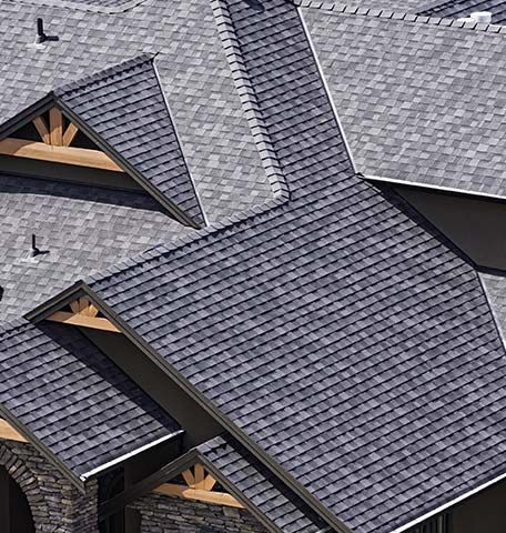 An aerial view of a house with a gray roof.