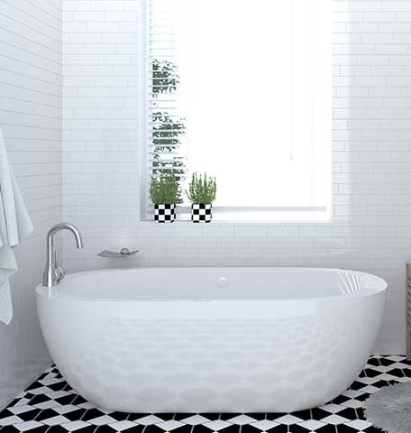 A white bathtub is sitting in a bathroom next to a window.