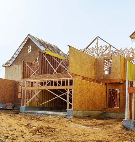 A house that is being built with a lot of wood