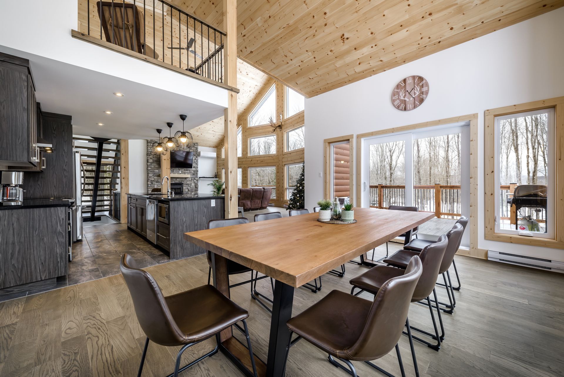 A dining room with a wooden table and chairs in a house.