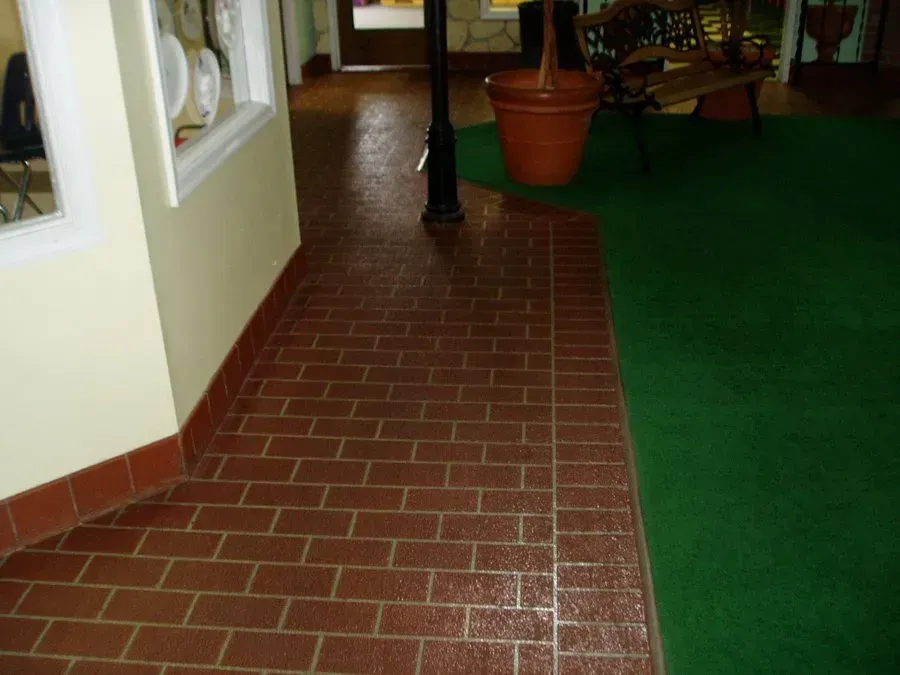 A brick floor and green carpet