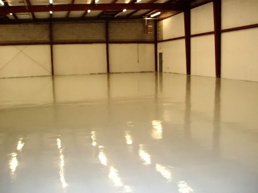 A large empty warehouse with a shiny floor